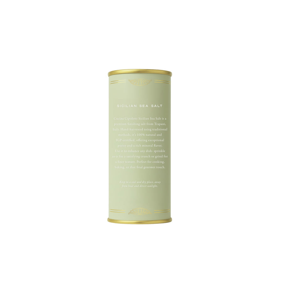 Cylindrical container of sea salt on a white background